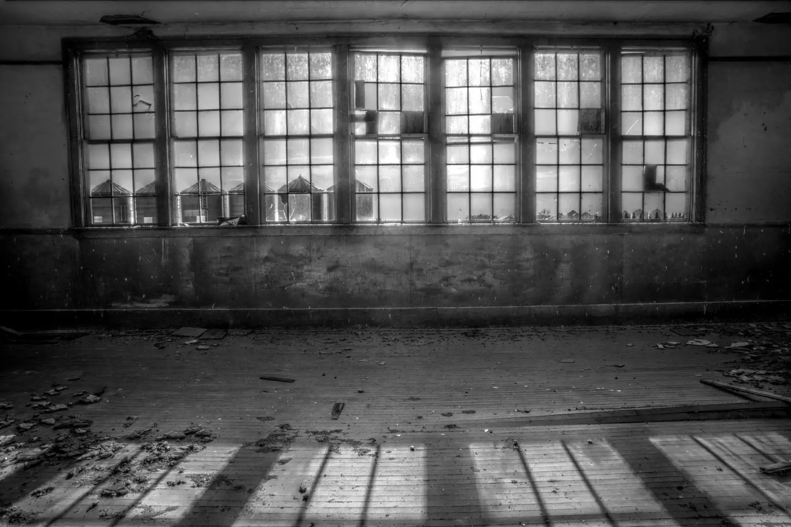 Inside the abandoned Menno School, windows looking out to grain bins